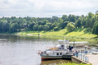 View to Nemunas river with tourist cruise ship and embankment in Druskininkai. Lithuania. Druskininkai is resort with health promotion, recreation, active lifestyle, exceptional entertainment.