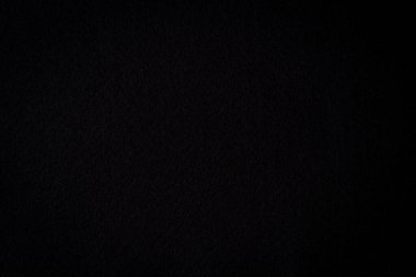 Black color felt textile fabric material texture background. Abstract monochrome black color background.