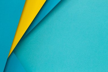 Soyut renk kağıtları geometri düz kompozisyon arka planı açık mavi ve sarı tonlu