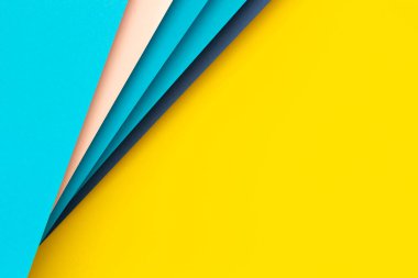 Abstract color papers geometry flat lay composition background with yellow, blue, pink color lines and shapes. Top view, copy space.