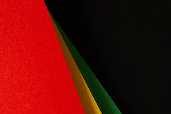 Black History Month color background. African American history month celebration. Abstract red, yellow, green, black color paper background.