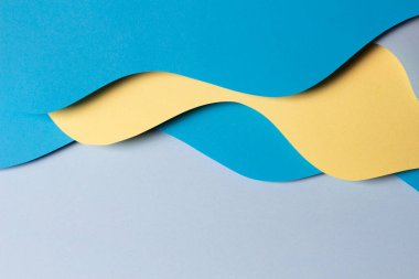 Soyut renkli kağıt dokusu arkaplanı. Minimum kağıt, geometrik şekil katmanları ve açık mavi ve sarı çizgilerle kompozisyonu keser. Üst görünüm.