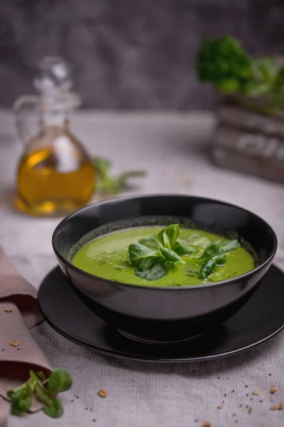 Vegetarian healthy soup. Green pea cream soup with mung bean salad