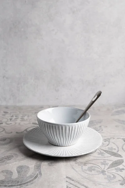 ceramic dishes on ceramic tiles with a pattern, vertical format