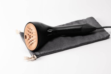 steam hand iron on a white background, gentle ironing, fabric care