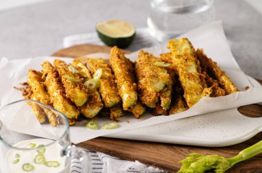 zucchini baked in breading, diet appetizer on a white plate
