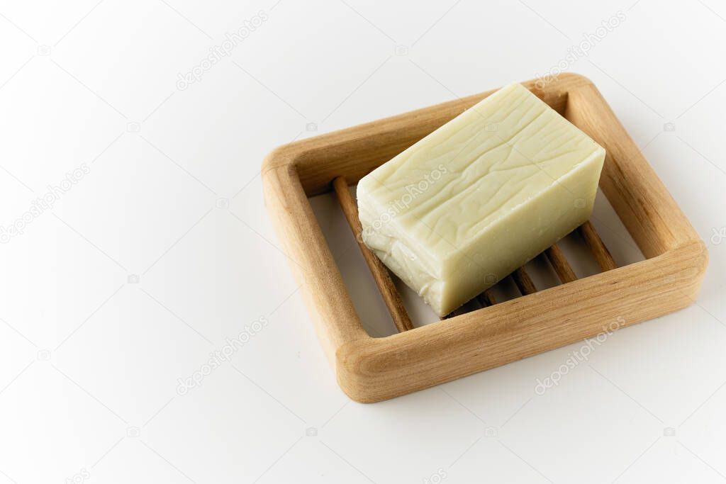 natural handmade soap, on a wooden stand and white background