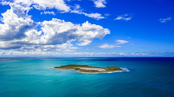 Islet in atlantic ocean. Small atoll in ocean. Tropical bliss in carribbean land. View on island from hill. Aquatic heaven and isle paradise.