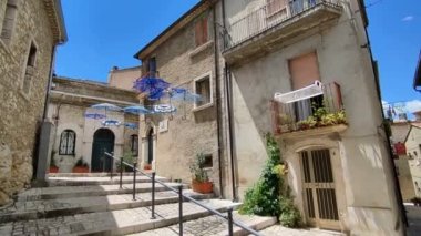 Oratino, Molise, Italy - July 13, 2022: Crochet umbrellas in the alleys of the historic center