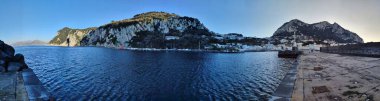 Capri, Campania, Italy - March 13, 2022: Panoramic photo of the Marina Grande port at sunset
