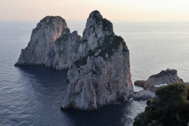 Capri, Campania, Italy - March 11, 2022: Faraglioni from the Via Pizzolungo path that connects Via Arco Naturale with the Belvedere Tragara