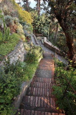 Capri, Campania, Italy - March 11, 2022: Section of the Via Pizzolungo path that connects Via Arco Naturale with the Belvedere Tragara along the faraglioni