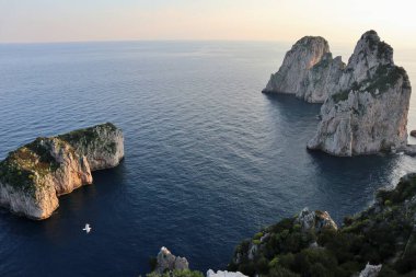 Capri, Campania, Italy - March 11, 2022: Faraglioni from the Via Pizzolungo path that connects Via Arco Naturale with the Belvedere Tragara
