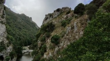 San Severino, Campania, İtalya - 18 Eylül 2022: Mingardo Köprüsü 'nün üzerindeki terk edilmiş San Severino di Centola köyünün yıkıntıları altında Şeytanın Boğazı' nın Genel Görünümü