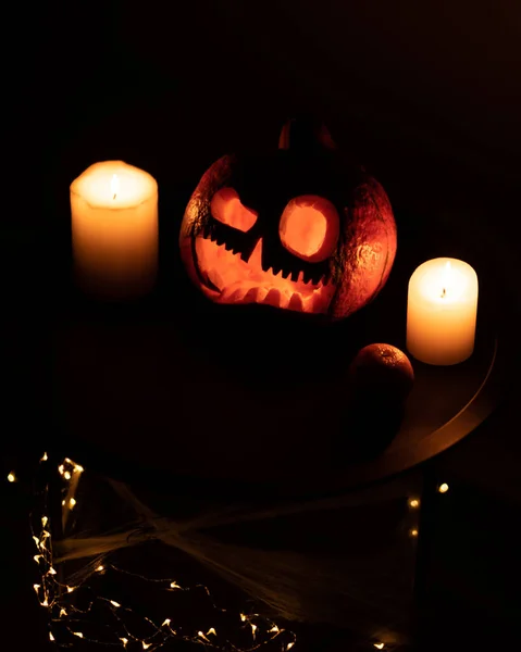 Cabeça Jack abóbora com sorriso assustador e velas em chamas para a noite de festa em fundo preto, conceito de Halloween — Fotografia de Stock