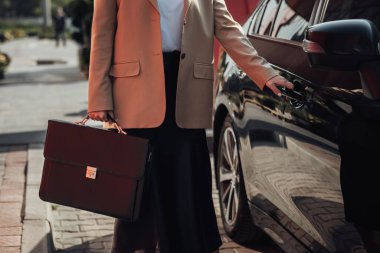 Lüks Arabasının Evrak Çantası Açan Kapısı Olan Tanınmaz Şık İş Kadını