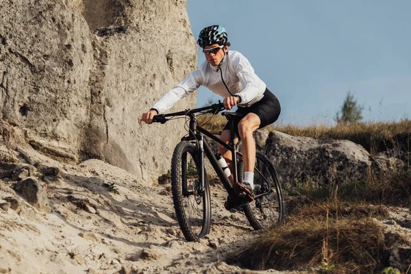 Equipped Professional Cyclist Descends a Slope on Mountain Bike, Sportsman Going Down from Hill on Bicycle