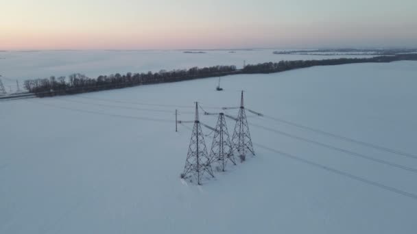 Aerial Drone View Power Lines Snowy Field Sunset — Stock videók