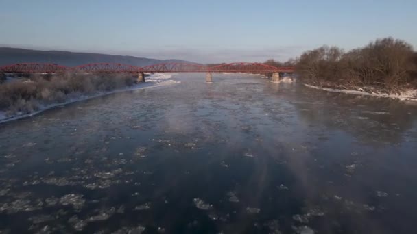 Drone Shot Flies Forward Frozen River Red Steel Bridge Aerial — стокове відео