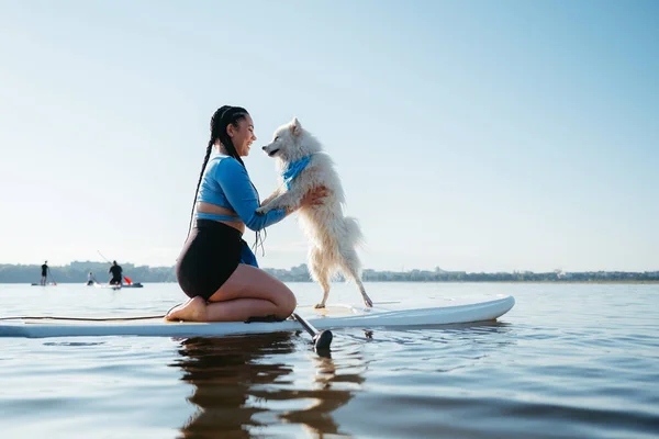 Happy Young Woman Locs Hugging Her Dog Japanese Spitz While — Foto Stock