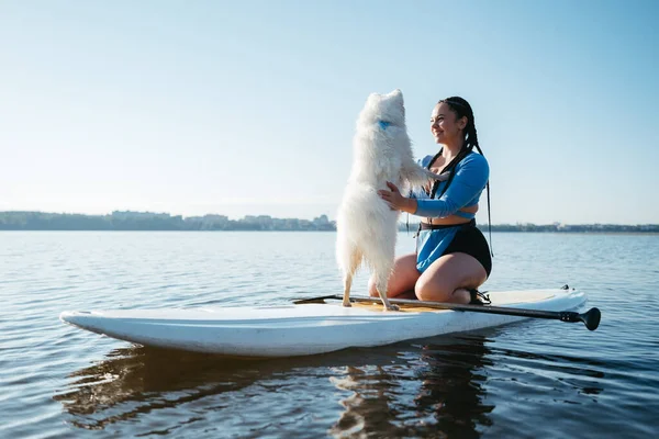 Happy Young Woman Hugging Her Dog Japanese Spitz While Sitting — Photo