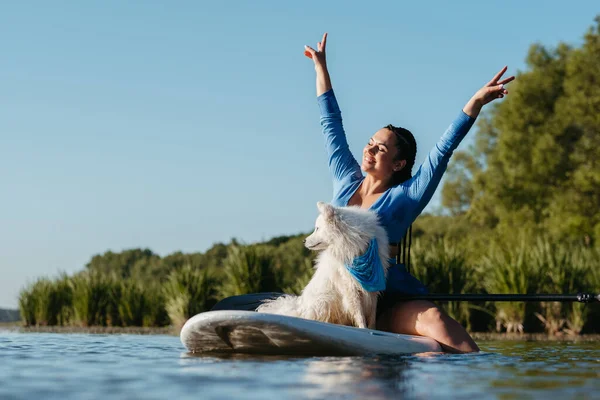 Happy Young Woman Raising Hands While Sitting Sup Board Her — Fotografia de Stock