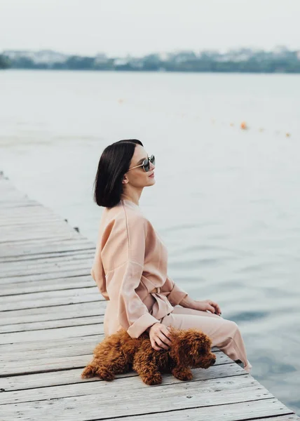 Brunette Woman Sitting Pier Her Redhead Dog Toy Poodle — Photo