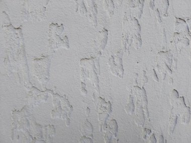 Plaster background. Cement wall texture with cracks. Old wall. Moisture is released through cracks in the cement wall. Photo