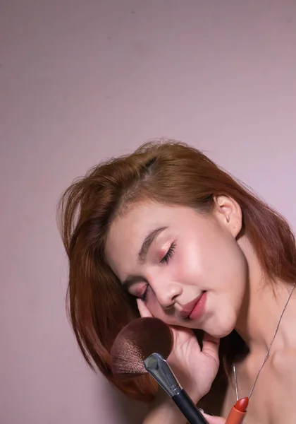Bastante Asiático Mujer Con Cosmético Lápiz Labial Cepillo Posando Estudio — Foto de Stock