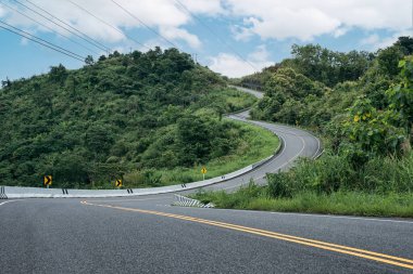 Nan, Tayland 'daki tropikal yağmur ormanlarında dağın tepesinde 3 kişi gibi dönen yol.