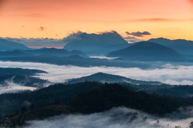 Beautiful sunrise over Doi Luang Chiang Dao mountain and foggy on hill in national park at Den TV viewpoint, Chiang Dao, Chiang Mai, Thailand