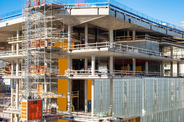 Construction of large building with concrete structure and steel scaffolding in downtown