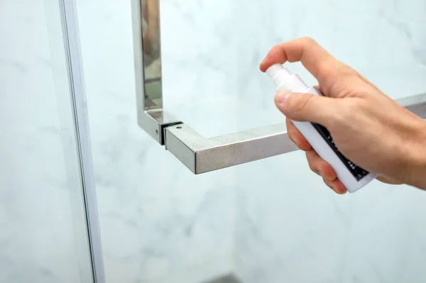 Hand Spraying Alcohol Sanitizer Door Handle Bathroom — стоковое фото