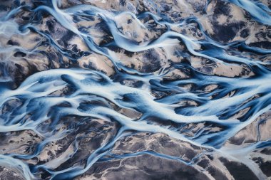 Aerial drone view of abstract beautiful glacier rivers pattern on earth in highlands of Iceland