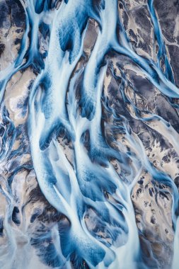 Aerial drone view of abstract beautiful glacier rivers pattern on earth in highlands of Iceland