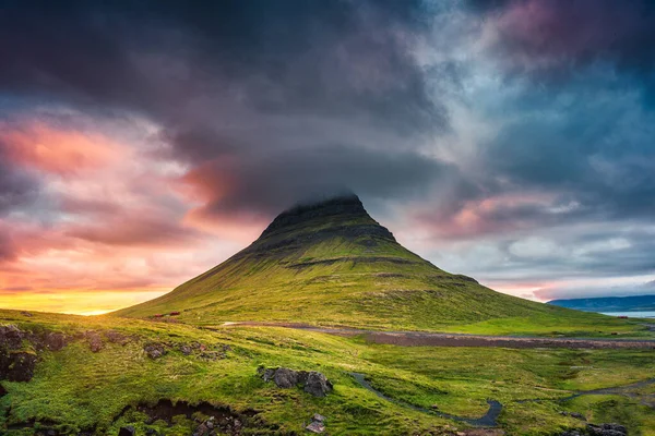 Fantastic landscape of sunset over Kirkjufell mountain with colorful pileus cloud on summer at Iceland