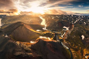 Aerial drone view of sunset over mysterious volcanic crater and glacier stretches through the central highlands of iceland on summer. Rauoibotn, Torfajokull and Myrdalsjokull glaciers