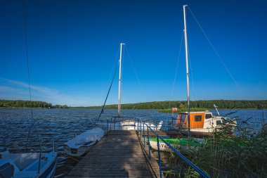 Jezioro Ostrowieckie, Poland - July 2020 : Private Boat landing and pier on a boat on Jezioro Ostrowieckie