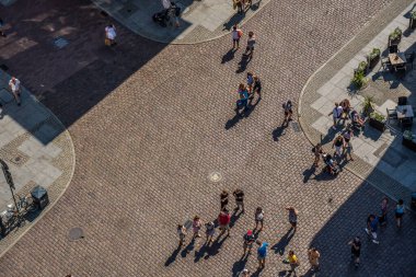 Torun, Poland - August 2020 : View of the people walking on the historical Cobblestoned streets in Torun Old town in summer, picture taken from high above viewing platform in the Ratusz Clock tower clipart