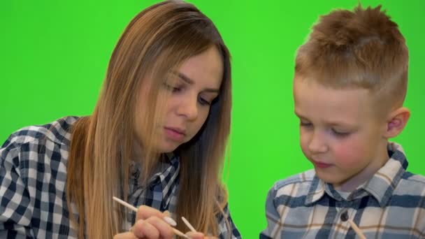 Mom and son painting Easter eggs, chroma key — Stock Video