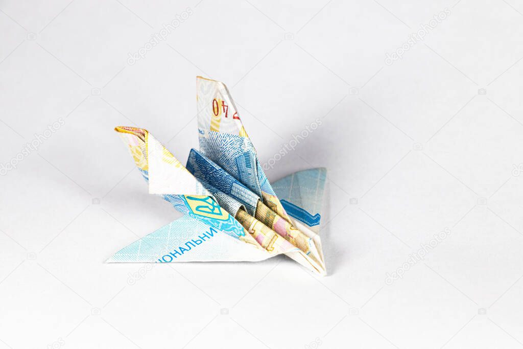 An airplane made from a paper bill of the Ukrainian hryvnia