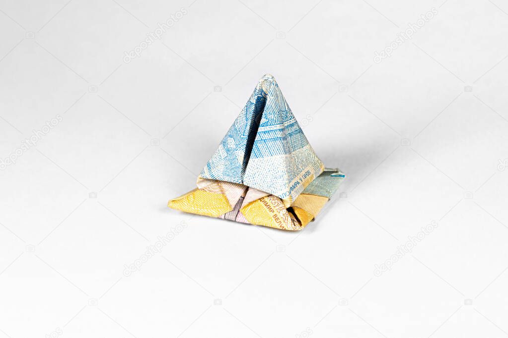 financial pyramid made from a paper bill of the Ukrainian hryvnia