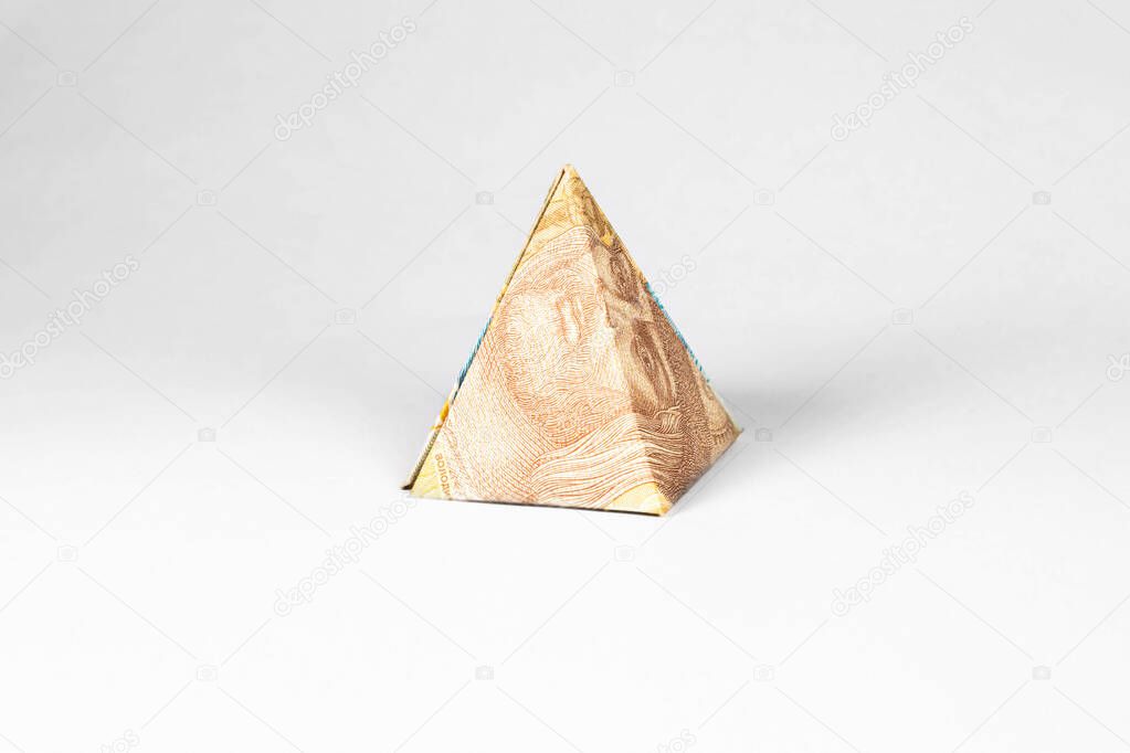 pyramid made from a paper bill of the Ukrainian hryvnia