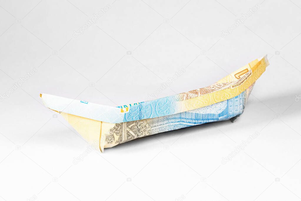 boat made from a paper bill of the Ukrainian hryvnia