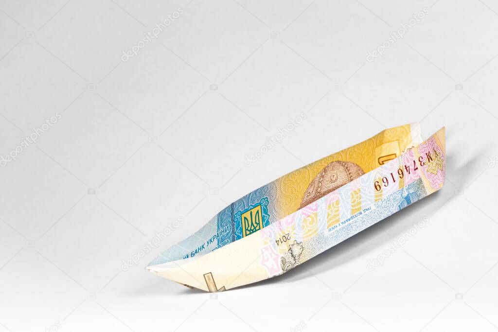 boat made from a paper bill of the Ukrainian hryvnia