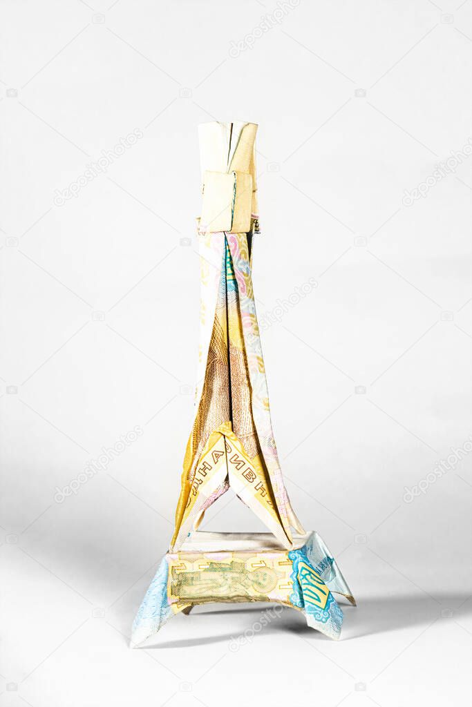 eiffel tower from paris made from a paper bill of the Ukrainian hryvnia