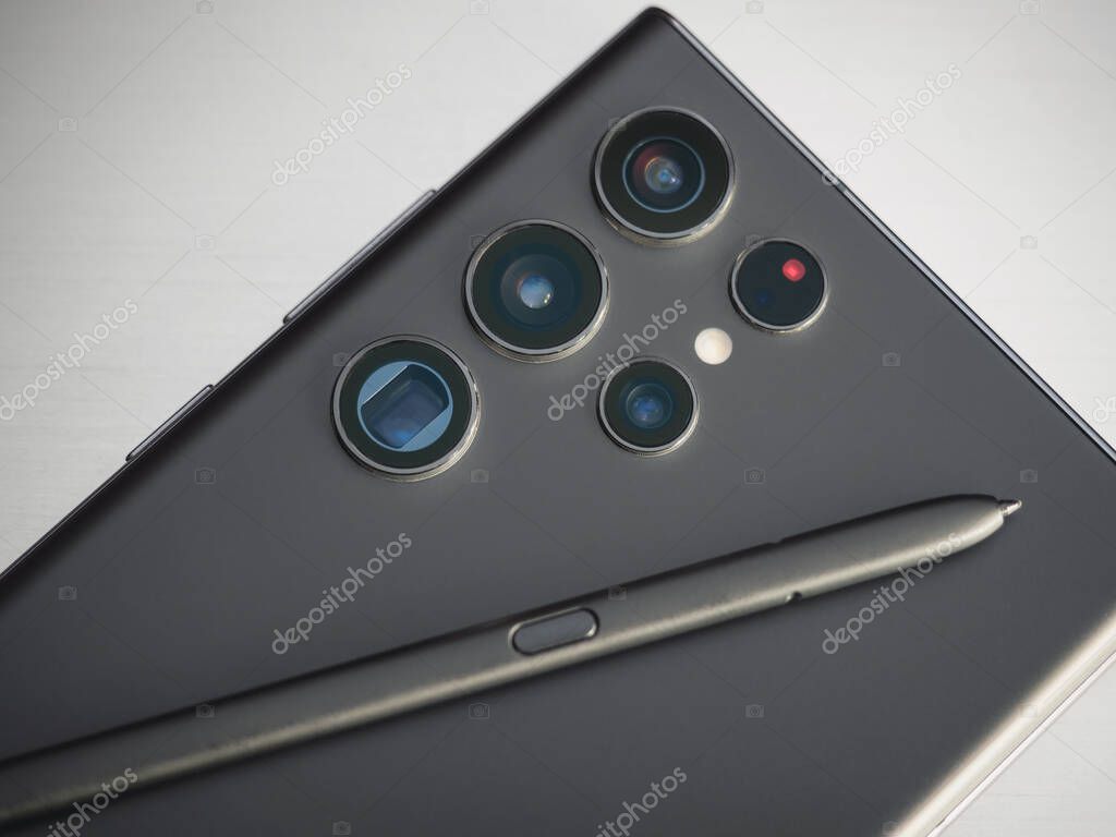 Galati, Romania: June 29, 2022: The new Samsung Galaxy S22 Ultra back with camera lenses and SPen on grey background