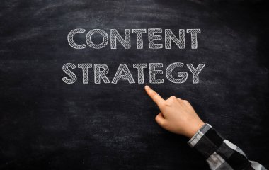 Man points to text Content Strategy written on blackboard closeup. Filling sites with information about business. Communication with customers