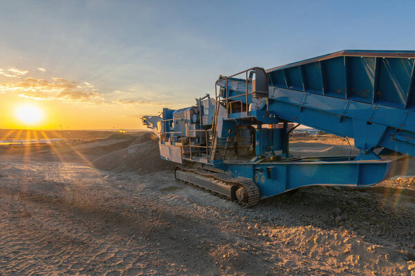 Heavy and mobile machinery in a quarry to transform stone into construction material