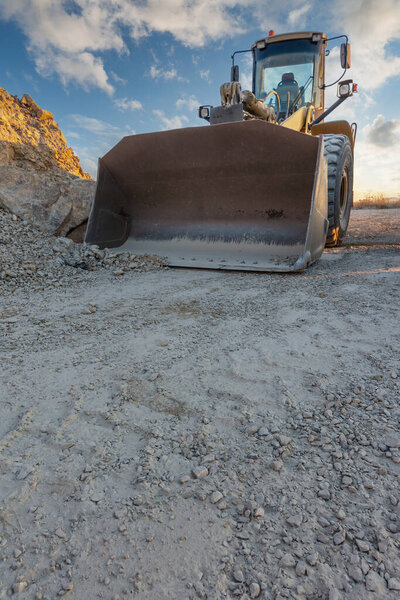 Excavator moving dirt and sand at a construction site